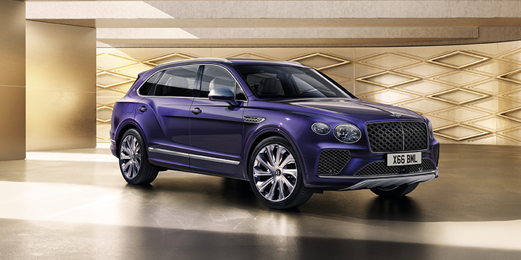 Bentley Perth Bentley Bentayga Extended Wheelbase Mulliner SUV front three quarter in Tanzanite Purple paint with a gold patterned background